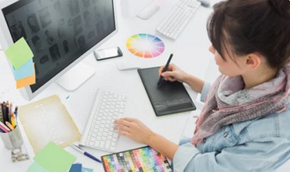 High angle view of an artist drawing something on graphic tablet at the office